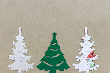 Tree Christmas trees made of paper on brown craft paper background