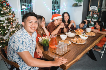 portrait of indonesian family having christmas eve dinner together at home