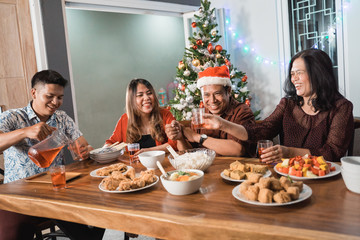 portrait of indonesian family having christmas eve dinner together at home