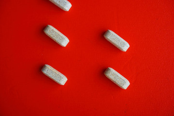 Brown capsules on a red background. Medicine and health care concept