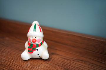 Christmas decorative small ceramic doll on timber table
