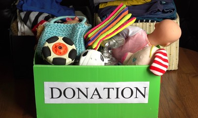 A box of children's toys ready for a garage sale or to donate to a charitable organization. Help...