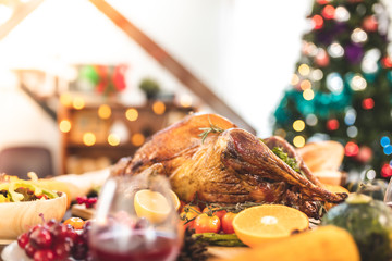 Roasted  chicken or turkey with sauce and grilled autumn vegetables: corn,pumpkin  on wooden table, top view, frame. Christmas or Thanksgiving Day food concept.