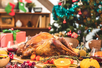 Roasted  chicken or turkey with sauce and grilled autumn vegetables: corn,pumpkin  on wooden table, top view, frame. Christmas or Thanksgiving Day food concept.