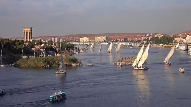 Beautiful landscape with felucca boats on Nile river in Aswan at sunset, Egypt, 4k