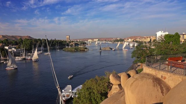 Beautiful landscape with felucca boats on Nile river in Aswan at sunset, Egypt, 4k