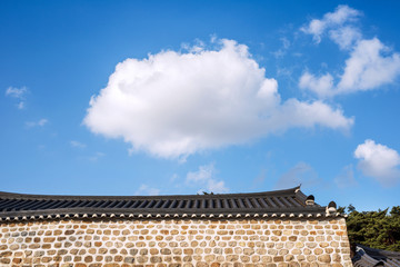 Korean traditional tiled roof and stone wall, ancient architecture of palace .