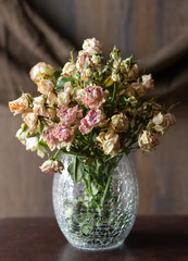 Withered bunch of roses in a vase, dried flowers