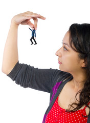 Gigantic woman holding a tiny little businessman as a metaphor for loss of self-confidence.  The...