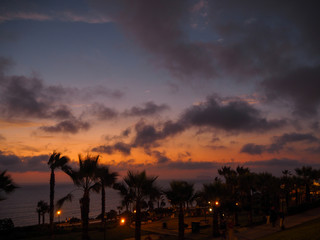 View of a sunset from a park in the city of Lima