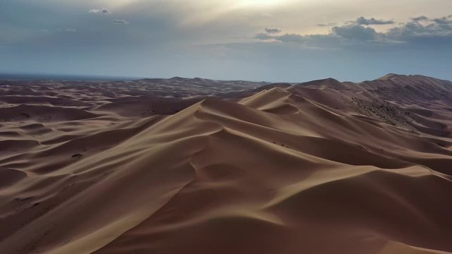 Aerial view of the sand dunes Hongoryn Els in Gobi Desert at sunset, Mongolia, 4k