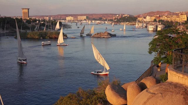 Beautiful landscape with felucca boats on Nile river in Aswan at sunset, Egypt, 4k