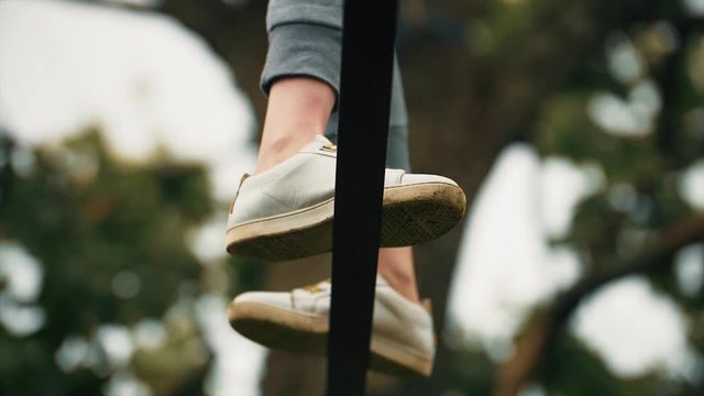 Close shoot of the feet of a woman walking on the rope with agility.