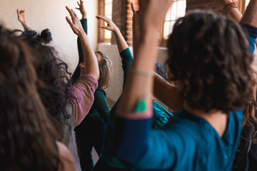 Dance workshop with women arms in the air