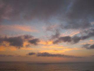 Naklejka na ściany i meble View of a sunset on the coast of the city of Lima