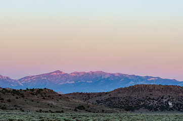 USA, Nevada, White Pine County, Nye County, Duckwater Valley. Alpenglow lights the west slope of the White Pine Range including Currant Mountain and Duckwater Peak.