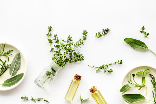 Medicine made from wildflowers and herbs with essential oils on white background top view pattern copy space