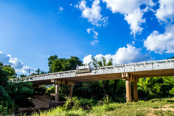 Concrete bridge over the river and blue sky.