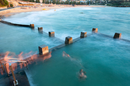Sydney coogee beach and sea pool at dawn with ghost swimmers