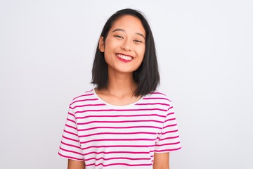 Obraz na płótnie Canvas Young chinese woman wearing striped t-shirt standing over isolated white background with a happy and cool smile on face. Lucky person.