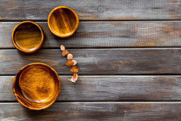 Making wooden dishes. Empty bowls on dark wooden background top view copy space