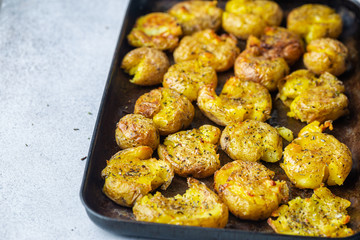 Homemade baked smashed baby potatoes with garlic, salt and herbs