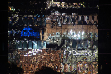 Facade a glass wall of a modern building with reflection of building, pattern or background in Bangkok,Thailand..