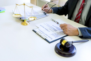 Lawyer or judge use magnifier glass look to the paper