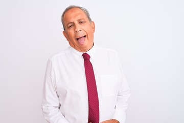 Senior grey-haired businessman wearing elegant tie over isolated white background sticking tongue out happy with funny expression. Emotion concept.