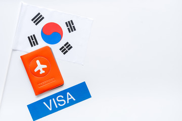 Visa to Korea concept. Korean flag near passport on white background top-down copy space