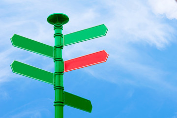 Blank direction sign with 5 arrowsn sky background.