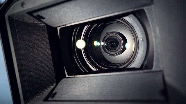 Close-up of camcorder lens, camera rotation and zoom lens. 4k