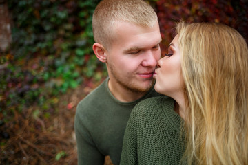 Fototapeta premium Beautiful couple walking down the street in sweaters and jeans