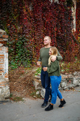 Fototapeta premium Beautiful couple walking down the street in sweaters and jeans