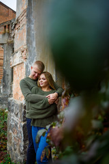 Beautiful couple walking down the street in sweaters and jeans