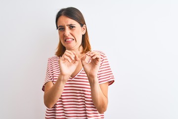 Beautiful redhead woman wearing casual striped red t-shirt over isolated background disgusted...