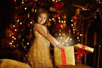 girl opens box with gifts