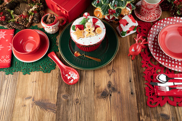 Christmas time. Christmas tableware and decorations. Red and brown colors. Rustic wooden background.