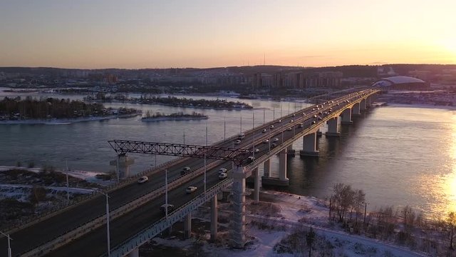 A bridge in a snow-covered city. Video from the drone