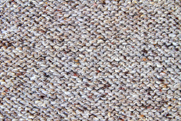 Brown or gray knitted textured background. Closeup