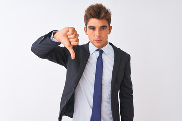 Young handsome businessman wearing suit standing over isolated white background looking unhappy and angry showing rejection and negative with thumbs down gesture. Bad expression.