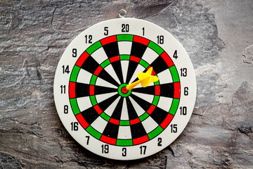 Darts game - simple sport for lesure time. Dartboard and arrows or dart on grey background top view