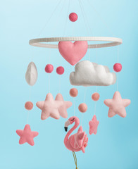 Colorful and eco-friendly children's mobile from felt for children. On blue background.
