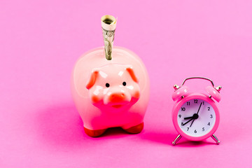 Banking account. Economics and finance. It is time to pay. Piggy bank stuffed dollar cash and alarm clock. Financial crisis. Credit debt. Bankruptcy and debt. Pay for debt. Bank collector service