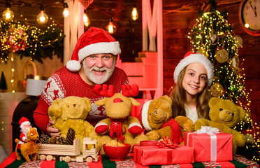 Fototapeta na wymiar Lovely gift. Festive tradition. Happy childhood. Gift surprise. Gift teddy bear toy for kid. Boxing day. Family values. Child enjoy christmas with grandfather Santa claus. Happiness and joy