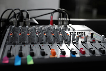 Modern audio mixing console, closeup. Music equipment