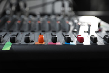 Modern audio mixing console, closeup. Music equipment