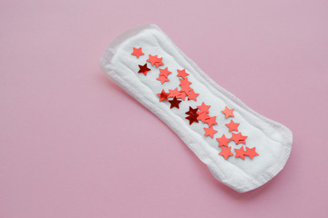 Daily, menstrual woman pad (napkin) for hygiene or blood period with red stars as a symbol of blood discharge Conception of woman's health, menstruation, PMS,  period- gynecological menstruation cycle