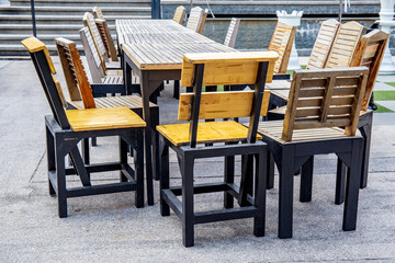 Empty painted wooden food table or plank with chair or bench on background for product display.