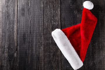 Santa Claus hat on wooden rustic background